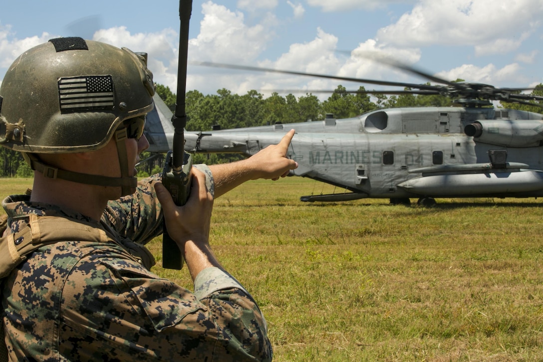 Cpl. Robert Blakeslee, an electric equipment repair specialist with 2nd Air Naval Gunfire Liaison Company, coordinates with the pilot of a CH-53E Super Stallion July 28, 2016 during a troop lift exercise at Marine Corps Air Station New River. The CH-53E Super Stallion is the largest helicopter in the United States military, and able to carry a 26,000-pound Light Armored Vehicle, 16 tons of cargo, or enough combat-loaded Marines to lead an assault or humanitarian operation. The capabilities provided by the CH-53E strengthen the expeditionary capabilities of Marines Corps units and make this aircraft one of the most useful in the Marine Corps. The CH-53E and pilot are assigned to Marine Heavy Helicopter Squadron 461, Marine Aircraft Group 29, 2nd Marine Aircraft Wing. ANGLICO is part of the II Marine Expeditionary Force Headquarters Group. (U.S. Marine Corps photo by Lance Cpl. Luke Hoogendam)