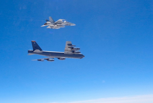 A Canadian CF-18 fighter jet intercepts a B-52 Stratofortress from the 2nd Bomb Wing, Barksdale Air Force Base, La., over the Atlantic in support of POLAR ROAR, Aug. 1, 2016. The B-52 flew non-stop from the U.S. to the Baltic Sea and back to conduct the intercept training with NORAD-assigned Canadian fighter aircraft and NATO allies. In total, three B-52s and two B-2 Spirit bombers from all three of the U.S.â€™s strategic bomber bases (Barksdale AFB, La.; Minot AFB, N.D.; and Whiteman AFB, Mo.) participated in POLAR ROAR, which also included flights to the Arctic and Alaska's Aleutian Islands.  Strategic bomber missions like POLAR ROAR ensure crews maintain the readiness and proficiency necessary to provide an always-ready global strike capability. (Photo courtesy of Canadian NORAD Region)