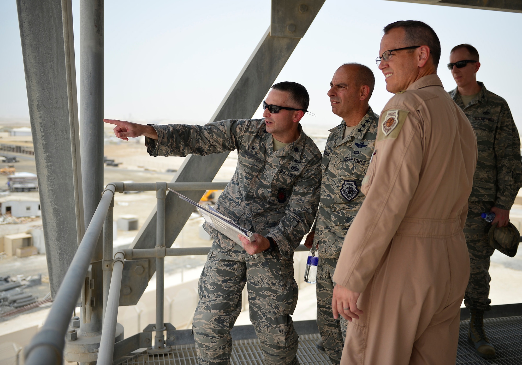 Lt. Col Casey Bartholomew, 380th Expeditionary Civil Engineer Squadron commander, discusses future base expansions with Lt. Gen. Jeffrey Harrigian, U.S. Air Forces Central Command commander, at an undisclosed location in Southwest Asia Aug. 1, 2016. This was Harrigian’s first visit to this operating location since taking command of AFCENT last month. (U.S. Air Force Photo by Tech. Sgt. Chad Warren/released)