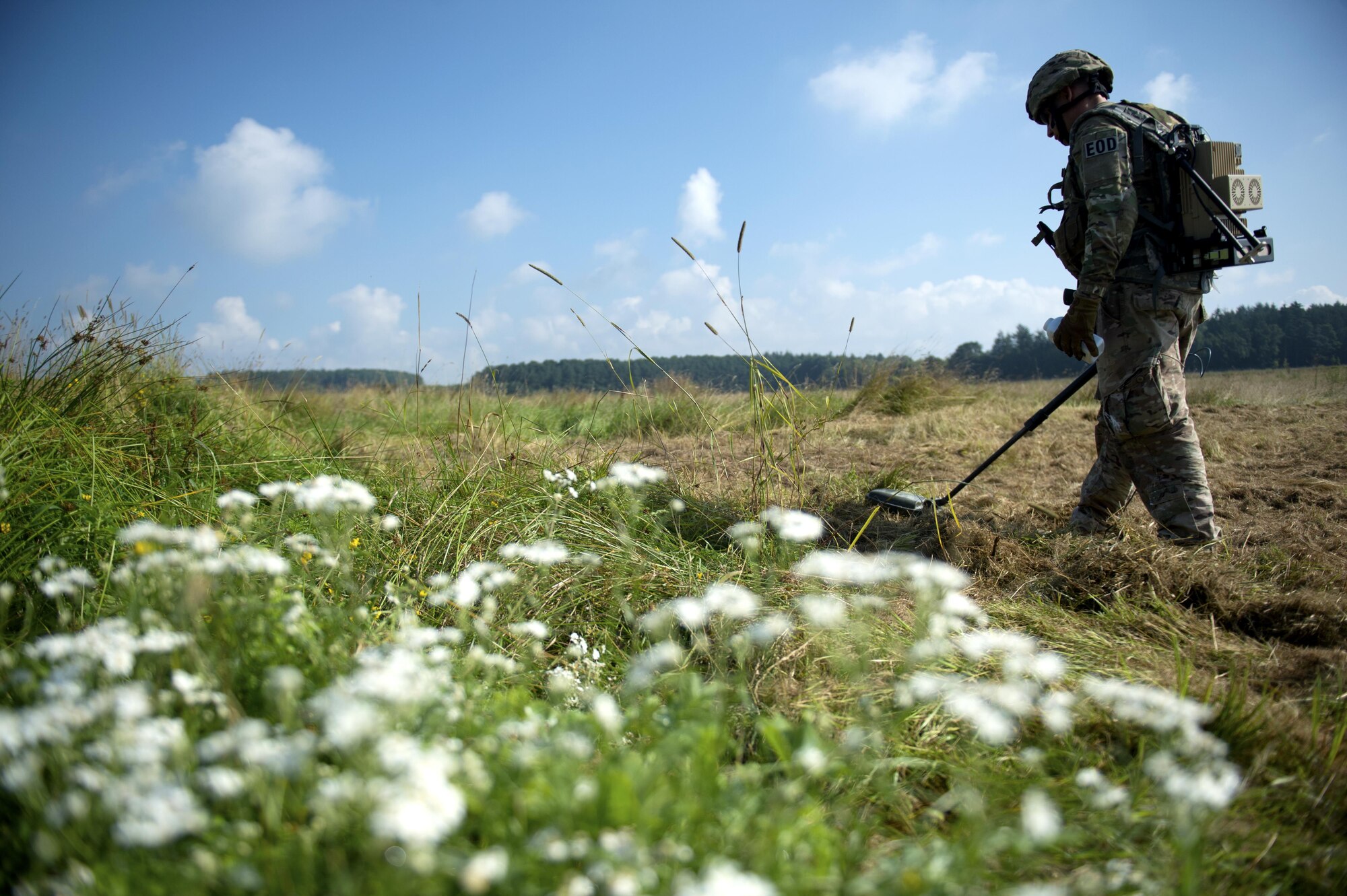 U.S. Air Force Tech. Sgt. Ryan Tennyson, 52nd Civil Engineer Squadron explosive ordnance disposal team leader, scans a field with a metal detector during an Improvised Explosive Device Rodeo at Spangdahlem Air Base, Germany, July 27, 2016. The exercise, known as the IED Rodeo, represented the first of its kind at Spangdahlem and featured a multilateral event showcasing EOD members from different branches and nations, how they locate explosive devices and the steps they take to safely and effectively disarm them. (U.S. Air Force photo by Airman 1st Class Preston L. Cherry/Realeased)