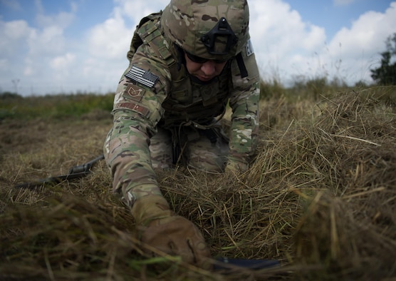 U.S. Air Force Tech. Sgt. Ryan Tennyson, explosive ordnance disposal team leader, uses a metal detecting wand to scan an area for simulated improvised explosive devices at Spangdahlem Air Base, Germany, July 27, 2016. This multilateral exercise focused on locating and disarming improvised explosive devices which involved EOD members from the U.S., Czech Republic, Germany and Belgium. (U.S. Air Force photo by Airman 1st Class Preston L. Cherry/Realeased)