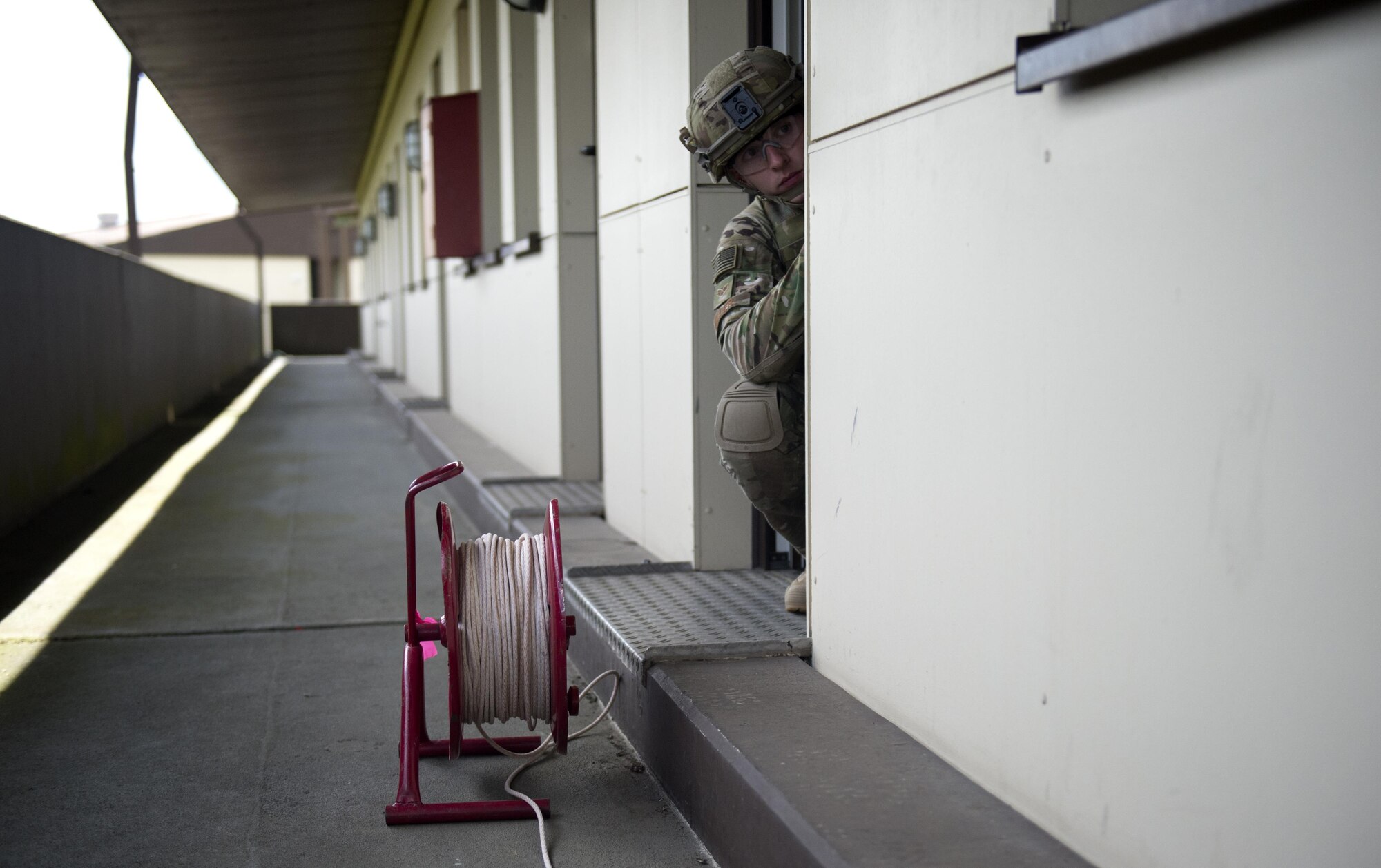 U.S. Air Force Senior Airman Vincent Miller, 52nd Civil Engineer Squadron explosive ordnance disposal team member, takes cover in a doorway during an Improvised Explosive Device Rodeo exercise at Spangdahlem Air Base, Germany, July 27, 2016. The exercise, known as the IED Rodeo, represented the first of its kind at Spangdahlem and featured a multilateral event showcasing EOD members from different branches and nations, how they locate explosive devices and the steps they take to safely and effectively disarm them. (U.S. Air Force photo by Airman 1st Class Preston L. Cherry/Realeased)