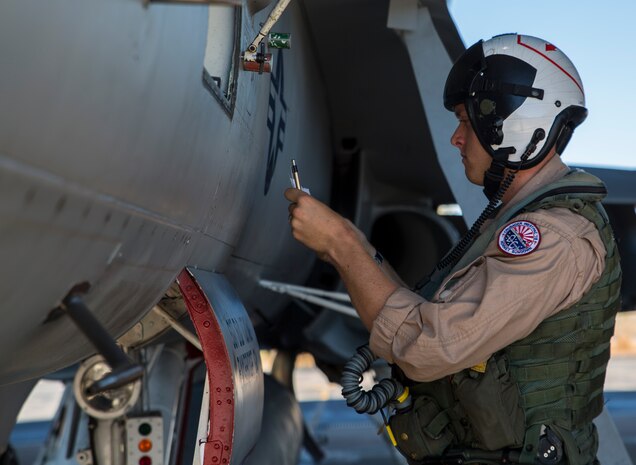 U.S. Marine Corps Capt. Daniel Lane, Marine Fighter Attack Squadron (VMFA) 122 pilot, conducts a preflight check on an F/A-18C Hornet during Exercise Pitch Black 2016 at Royal Australian Air Force Base Tindal, Australia, Aug. 1, 2016. Pitch Black 16 is a biennial, three week, multinational, large-force training exercise hosted by RAAF Tindal. As the training progresses, the U.S. pilots will also get the opportunity to fly with Canada, France, Germany, Indonesia, Netherlands, New Zealand and Thailand. (U.S. Marine Corps photo by Cpl. Nicole Zurbrugg)