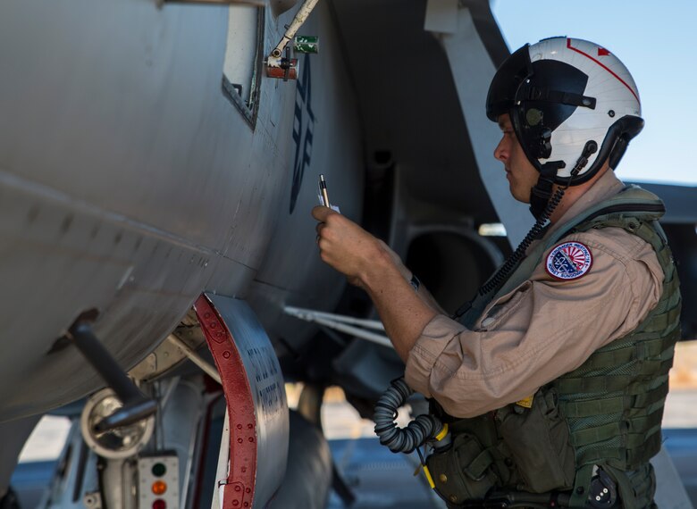 U.S. Marine Corps Capt. Daniel Lane, Marine Fighter Attack Squadron (VMFA) 122 pilot, conducts a preflight check on an F/A-18C Hornet during Exercise Pitch Black 2016 at Royal Australian Air Force Base Tindal, Australia, Aug. 1, 2016. Pitch Black 16 is a biennial, three week, multinational, large-force training exercise hosted by RAAF Tindal. As the training progresses, the U.S. pilots will also get the opportunity to fly with Canada, France, Germany, Indonesia, Netherlands, New Zealand and Thailand. (U.S. Marine Corps photo by Cpl. Nicole Zurbrugg)