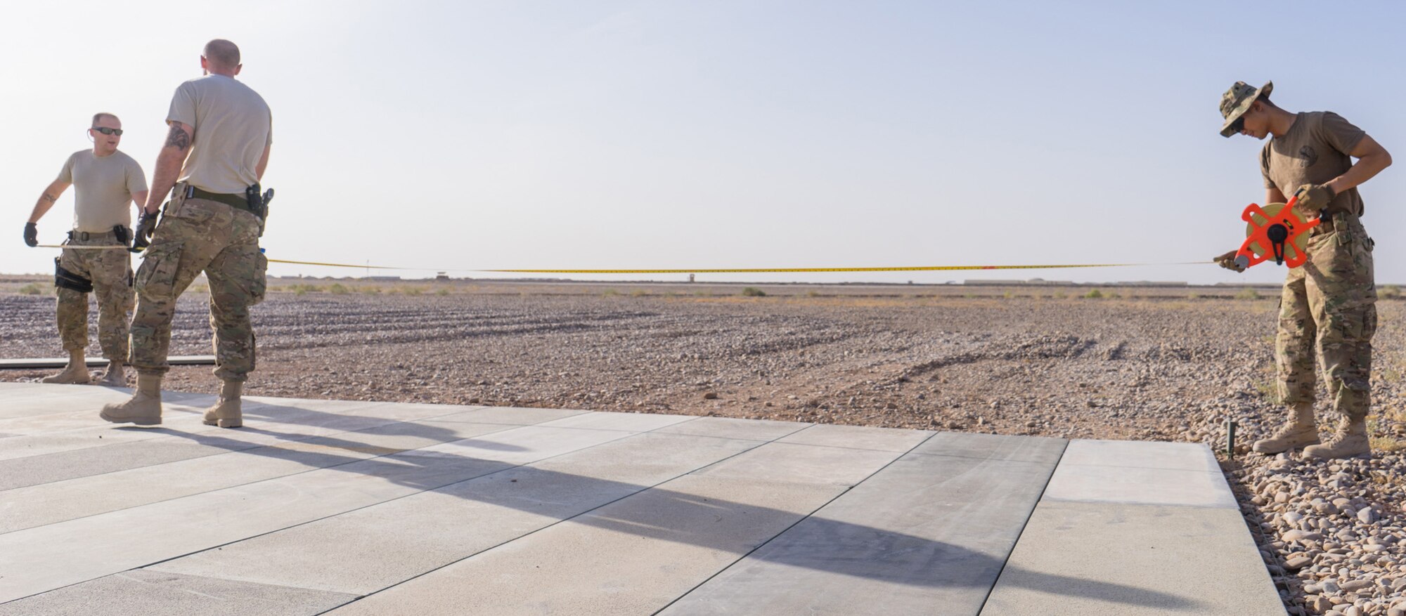 Staff Sgt. Joshua Ryan, Tech. Sgt. Dan Zimmerman, and Senior Airman Thet Tun (left to right), prepare to measure a helicopter landing zone, Camp Dwyer, Afghanistan, July 12, 2016. Airmen from the 451st Air Expeditionary Support Squadron helped build a helicopter landing zone at Camp Dwyer to support the medical facility. (Courtesy photo by 451 Air Expeditionary Support Squadron)