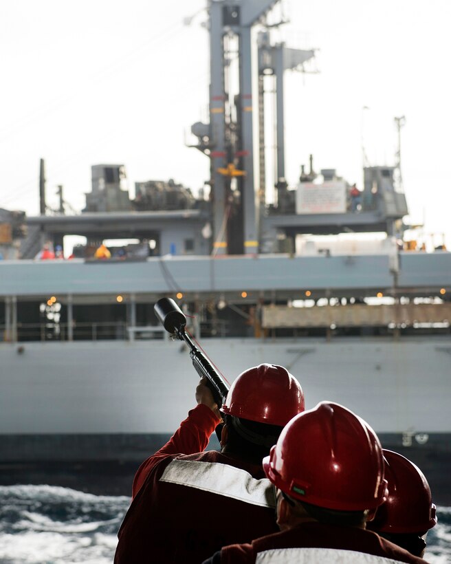 Sailors aboard the aircraft carrier USS Carl Vinson prepare to fire a shot line over to fleet replenishment oiler USNS Yukon during a replenishment at sea in the Pacific Ocean, July 26, 2016. Navy photo by Petty Officer 2nd Class Nathan K. Serpico