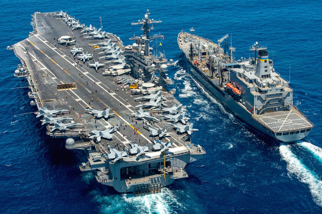 The aircraft carrier USS Carl Vinson conducts a replenishment at sea with fleet replenishment oiler USNS Yukon in the Pacific Ocean, July 26, 2016. Navy photo by Petty Officer 2nd Class Patrick W. Menah, Jr. 