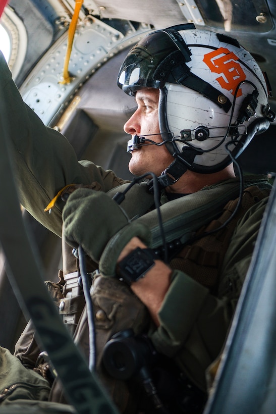 Navy Petty Officer 2nd Class Joshua Soderstrom flies an MH-60S Seahawk helicopter while the aircraft carrier USS Carl Vinson conducts a replenishment at sea with fleet replenishment oiler USNS Yukon in the Pacific Ocean, July 26, 2016. Soderstrom is a naval aircrewman. Navy photo by Petty Officer 2nd Class Patrick W. Menah Jr.