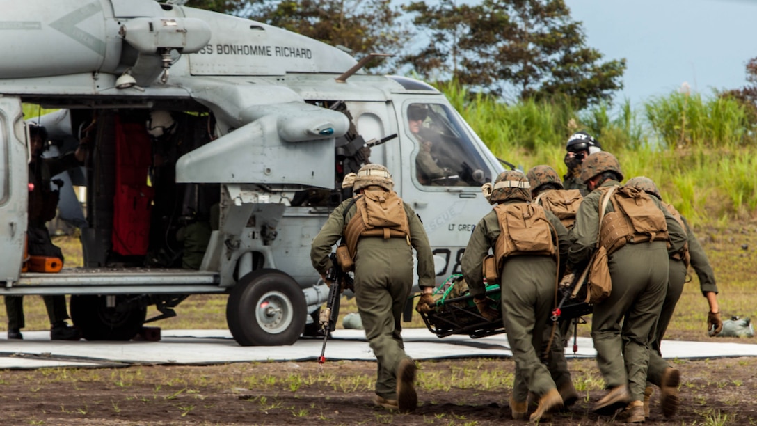 Expeditionary fire rescue Marines with Marine Wing Support Squadron 171 stationed at Marine Corps Air Station Iwakuni, Japan, carry a simulated casualty to a Sikorsky MH-60S Seahawk with Helicopter Sea Combat Squadron 25 during Exercise Eagle Wrath 2016 at Combined Arms Training Center Camp Fuji,Japan, July 28, 2016. During the culminating event Marines established a mock air base including a landing zone and refueling point, constructed defensive and machine-gun positions, and conducted convoys and patrols over the course of four days. 