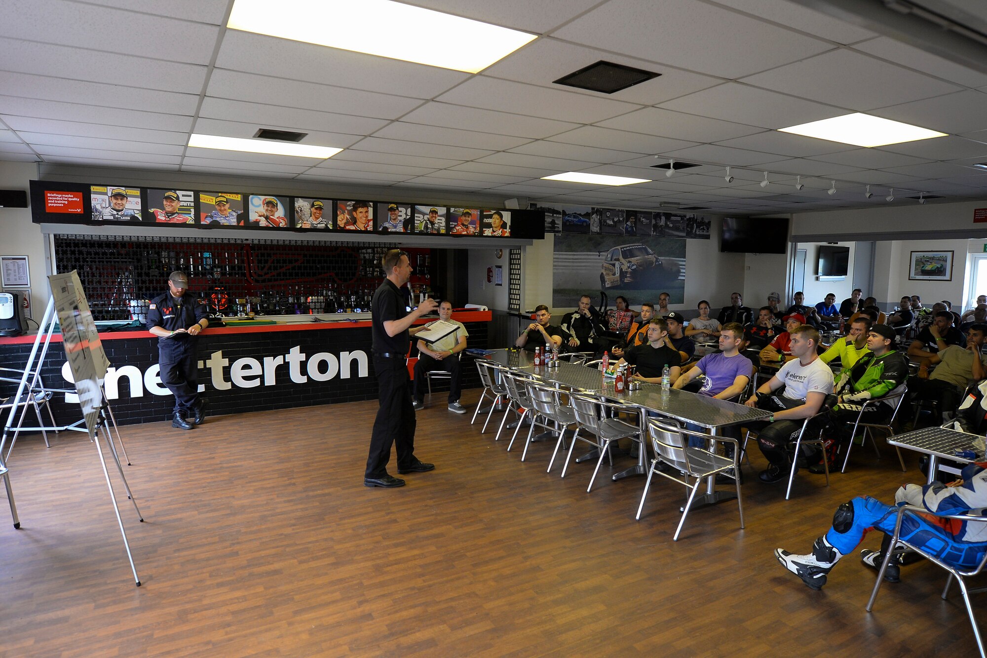 Giles Olley, Snetterton Circuit track instructor, gives a safety briefing to Military Track Day participants July 26, 2016, at Snetterton Circuit in Norwich, England. During the briefing riders were shown cornering techniques and flags used to communicate while on the track. (U.S. Air Force photo by Staff Sgt. Micaiah Anthony)