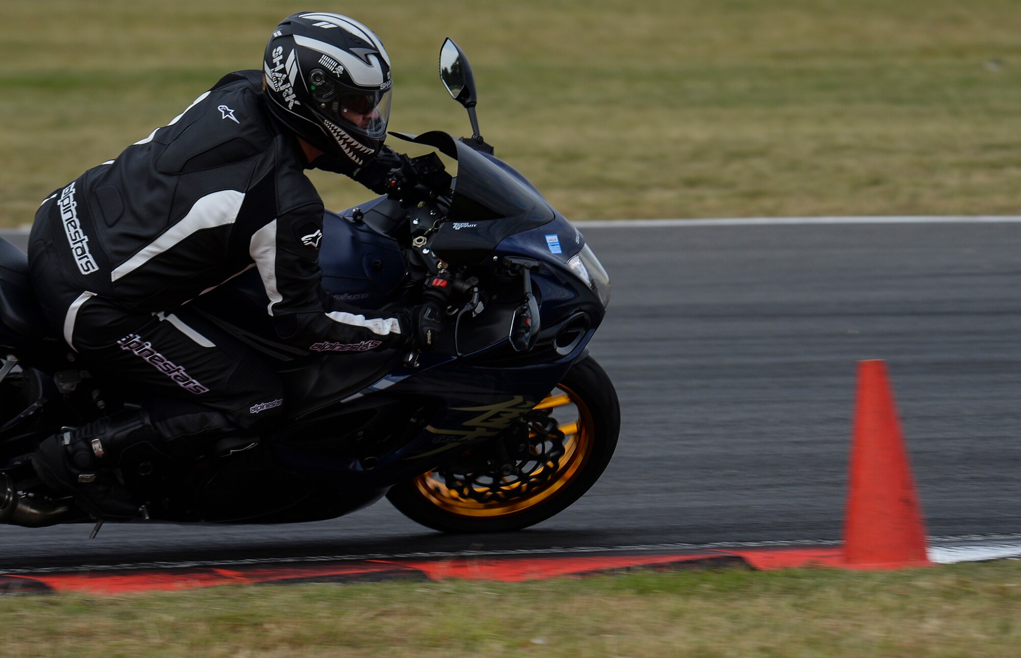 A participant in the Military Track Day enters the apex of a corner July 26, 2016, at Snetterton Circuit in Norwich, England. An apex is the innermost point of a line taken through a curve. When a rider hits the apex correctly it allows them to take the straightest line and maintain the highest speed though the corner. Instructors set up cones through the corners to mark the apex. (U.S. Air Force photo by Staff Sgt. Micaiah Anthony)