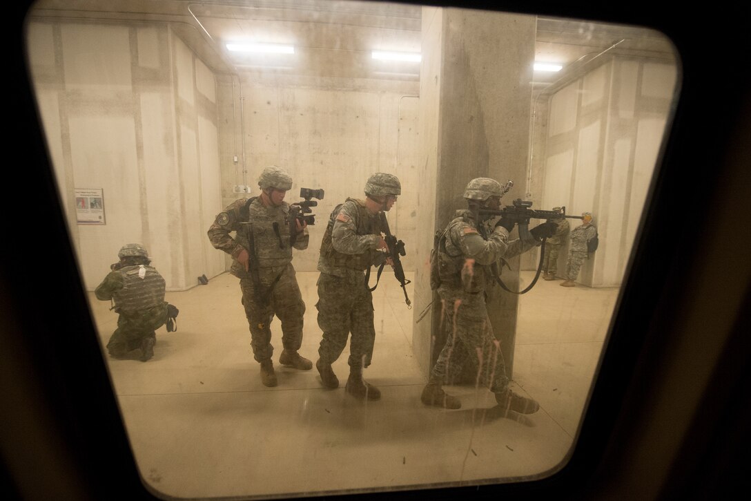 Combat camera photographers move with soldiers through a simulated subway station at Fort A.P. Hill, Va., July 27, 2016, during the North America Information Operations/Combat Camera Exercise. DoD photo by EJ Hersom