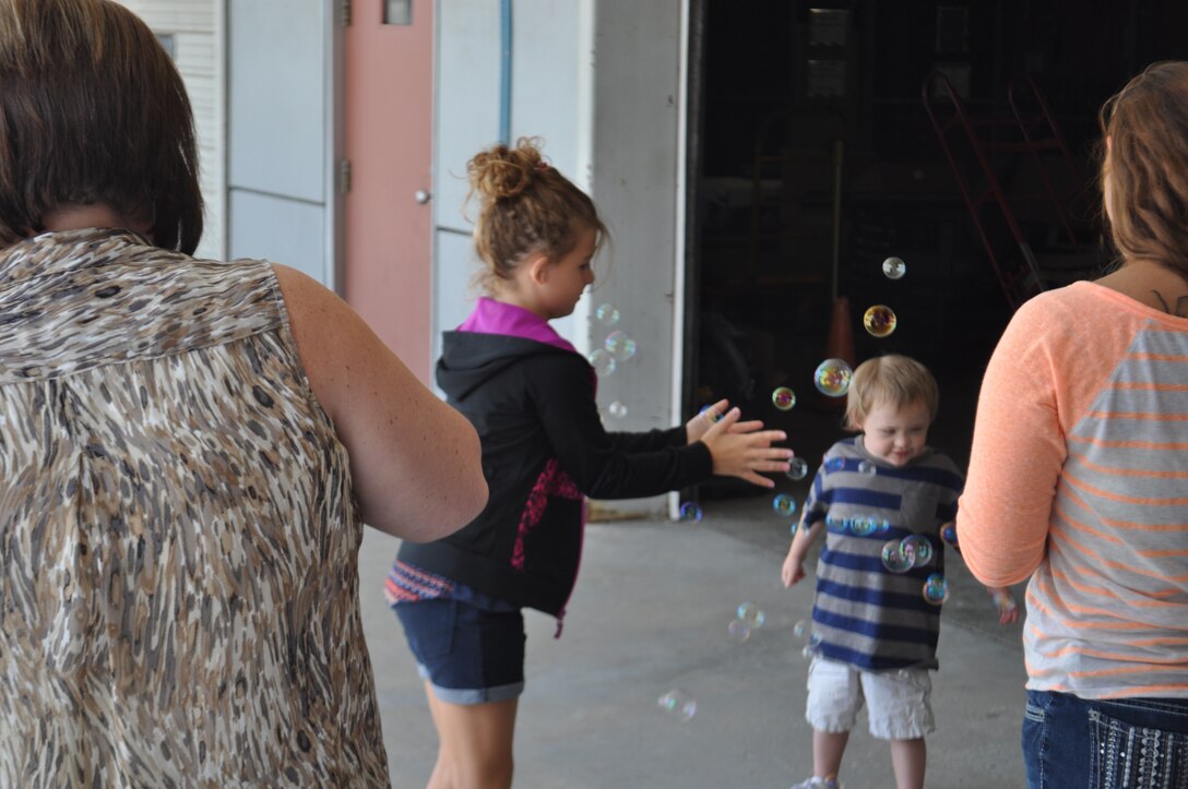 Young children enjoy bubbles during the 863rd Engineer Battalion Yellow Ribbon event and Family day. Family days are a chance for a unit’s families to come together and meet other family members, and share experiences, in a light and fun atmosphere. Yellow Ribbon events are designed to inform families of programs and resources available (U.S. Army photo by Spc. Brianna Saville/Released).