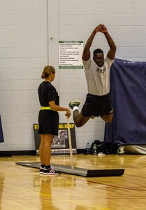 Army Reserve instructor from Task Force Wolf grades a Cadet performing the standing long jump for the Occupational Physical Assessment Test (OPAT) at U.S. Army Cadet Command during Cadet Summer Training (CST16), Ft. Knox, Kentucky, July 25. (U.S. Army Reserve photo by Sgt. Karen Sampson/ Released)