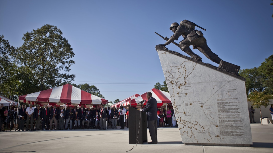 U.S. service members and guests listen to the National Chaplain of the Montford Point Marine Association,  Reverend James E. Moore, as he delivers the invocation during the Montford Point Marine Memorial dedication ceremony held at Jacksonville, North Carolina, July 29, 2016. The memorial was built in honor of the 20,000 African-Americans who attended training at Montford Point. 