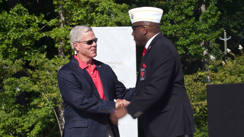 General (Ret) James F. Amos, left, 35th Commandant of the Marine Corps, and Forest E. Spencer, National President of the Montford Point Marine Association, greet each other during the Montford Point Marine Memorial dedication ceremony held at Jacksonville, North Carolina, July 29, 2016. The memorial was built in honor of the 20,000 African-Americans who attended training at Montford Point. 