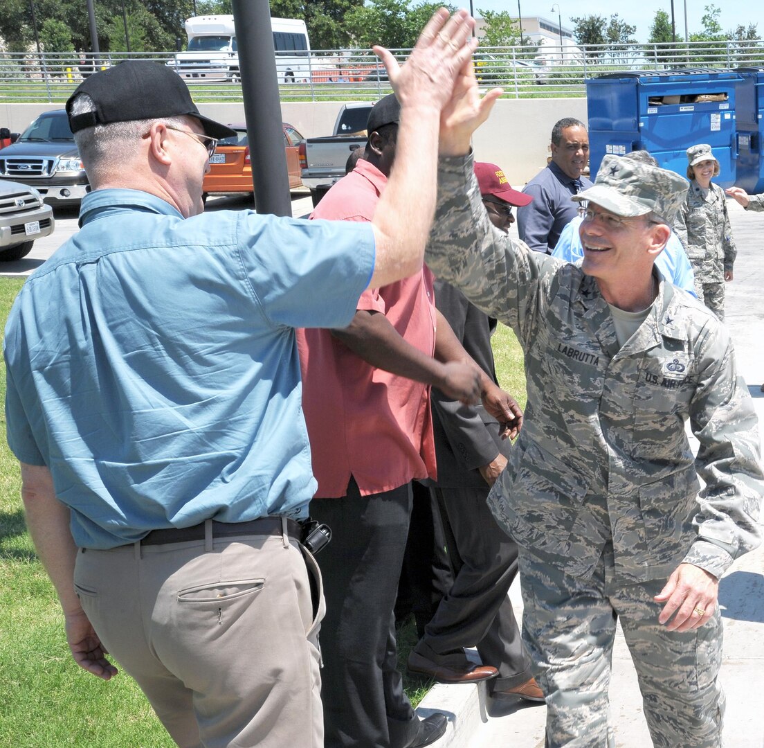 Brig. Gen. Bob LaBrutta (right), 502nd Air Base Wing and Joint Base San Antonio commander, greets a civilian June 3, 2013 during a tour of JBSA-Fort Sam Houston.
