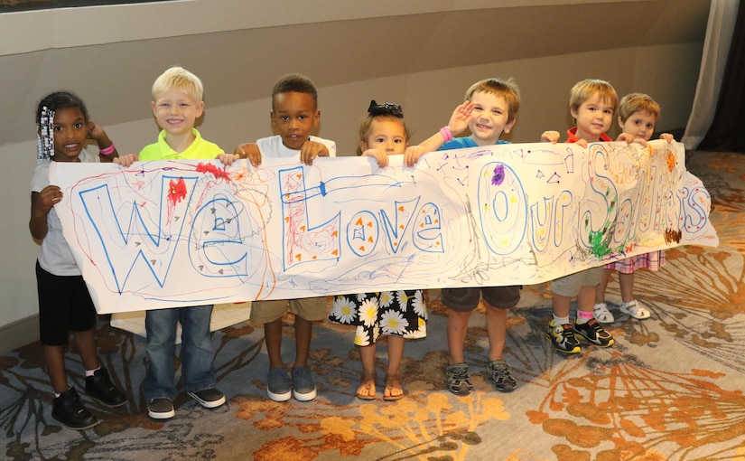 A group of children proudly display their artwork created during a Yellow Ribbon Reintegration Program event held in Atlanta, Georgia July 29-31, 2016.  The event provides Army Reserve Soldiers and their families with information, services, referrals and proactive outreach opportunities throughout the entire deployment cycle.  Its goal is to effectively prepare Soldiers and families for mobilization, sustain families during the mobilization process and reintegrate Soldiers with their families, communities and employers upon redeployment or release from active duty. Free childcare is provided to the families during the event and the kids are given numerous activities to keep them busy and let them have some fun. (Official U.S. Army Reserve photo by Sgt. 1st Class  )