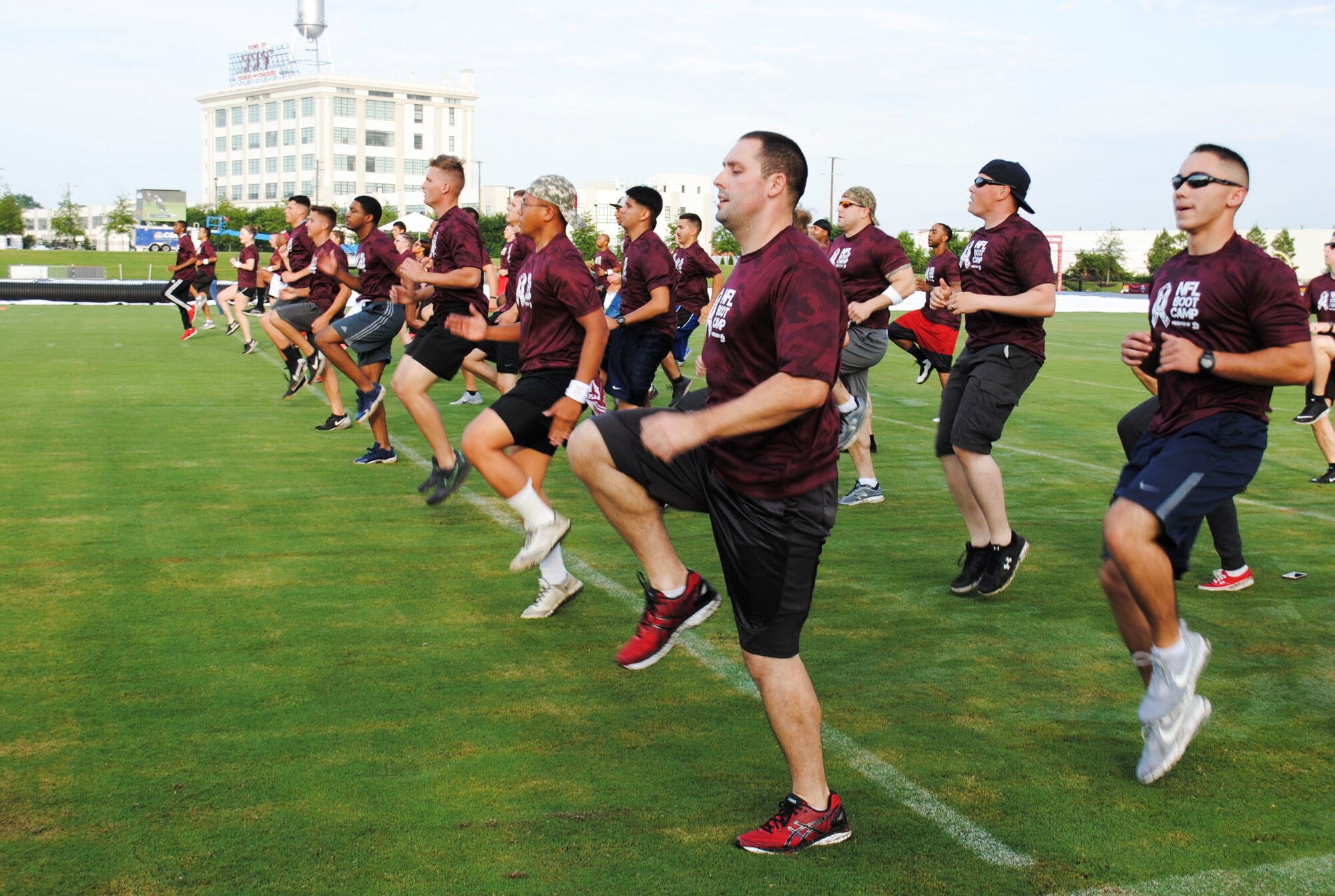 Service members perform warm-up exercises prior to the start of the mini boot camp July 28, 2016 at Bon Secours Washington Redskins Training Center in Richmond, Va. Service members from the Air Force, Navy, Army, Coast Guard and Marines were invited to participate in a mini boot camp and attend a NFL training camp. (U.S. Air Force photo by Tech. Sgt. Darnell T. Cannady)