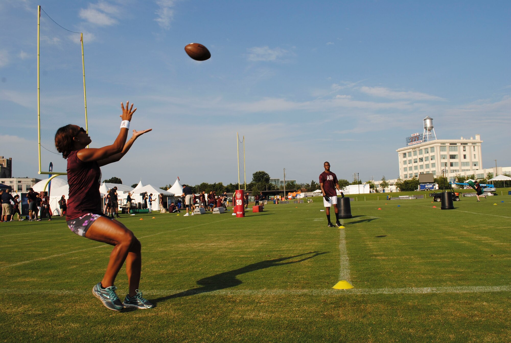 Team Coast Guard tries to catch footballs for points during the mini boot camp July 28, 2016 at Bon Secours Washington Redskins Training Center in Richmond, Va. After the drills, the military members ate breakfast, Redskin’s merchandise was raffled off and the winning teams of the Army and Air Force was announced. (U.S. Air Force photo by Tech. Sgt. Darnell T. Cannady)