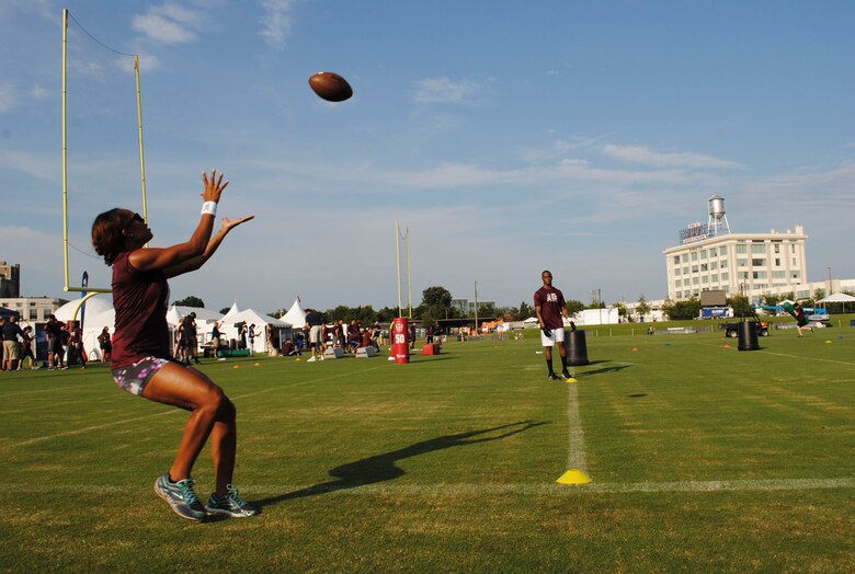 Team Coast Guard tries to catch footballs for points during the mini boot camp July 28, 2016 at Bon Secours Washington Redskins Training Center in Richmond, Va. After the drills, the military members ate breakfast, Redskin’s merchandise was raffled off and the winning teams of the Army and Air Force was announced. (U.S. Air Force photo by Tech. Sgt. Darnell T. Cannady)