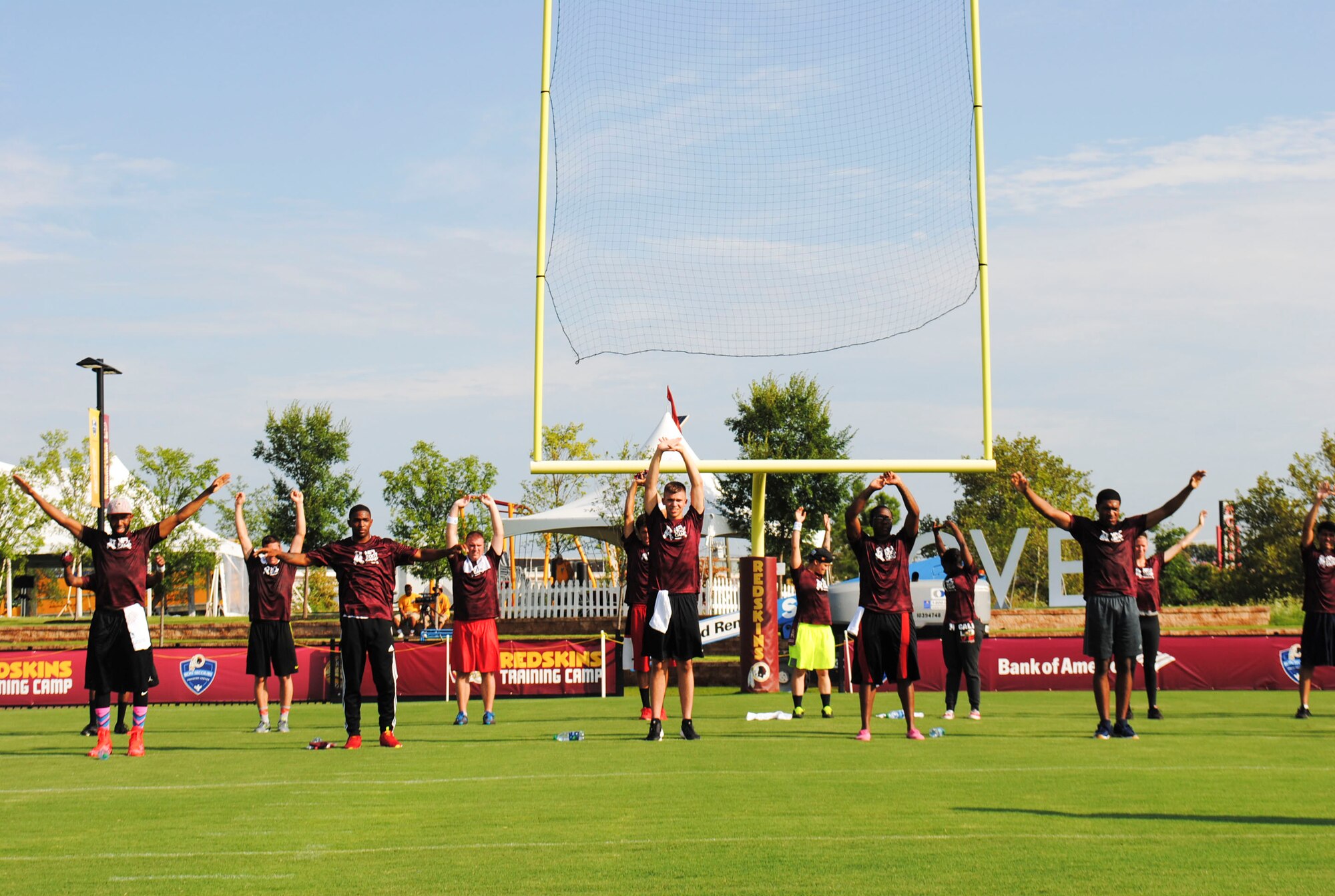 Service members perform warm-up exercises prior to the start of the mini boot camp July 28, 2016 at Bon Secours Washington Redskins Training Center in Richmond, Va. Service members from the Air Force, Navy, Army, Coast Guard and Marines were invited to participate in a mini boot camp and attend a NFL training camp. (U.S. Air Force photo by Tech. Sgt. Darnell T. Cannady)