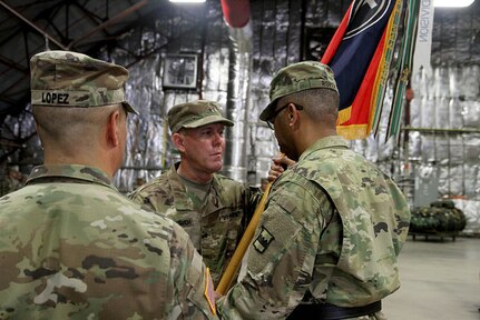 Brig. Gen. Steven Ainsworth, outgoing commander of the 94th Training Division, hands the command colors to Maj. Gen. A.C. Roper, commander of the 80th Training Command, during a change of command ceremony at Fort Lee Va., July 23, 2016. Roper handed the colors to Brig. Gen. Hector Lopez who is now the 94th TD’s new commander.