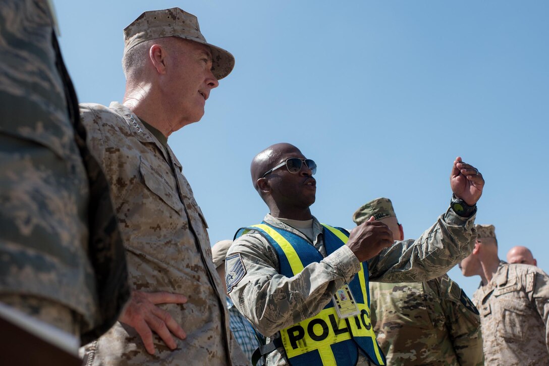 Marine Corps Gen. Joe Dunford, chairman of the Joint Chiefs of Staff, listens to Air Force Master Sgt. Gaston brief him as he observes airmen participating in a field exercise at Incirlik Air Base, Turkey, Aug. 2, 2016. DoD photo by Navy Petty Officer 2nd Class Dominique A. Pineiro