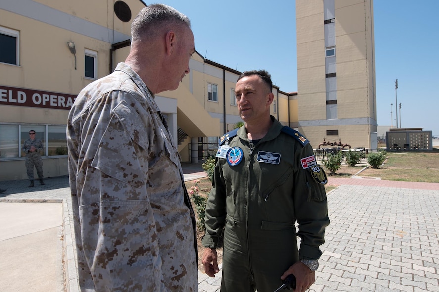 Marine Corps Gen. Joe Dunford, left, chairman of the Joint Chiefs of Staff, speaks with Turkish Air Force Brig. Gen. Kemal Turan.