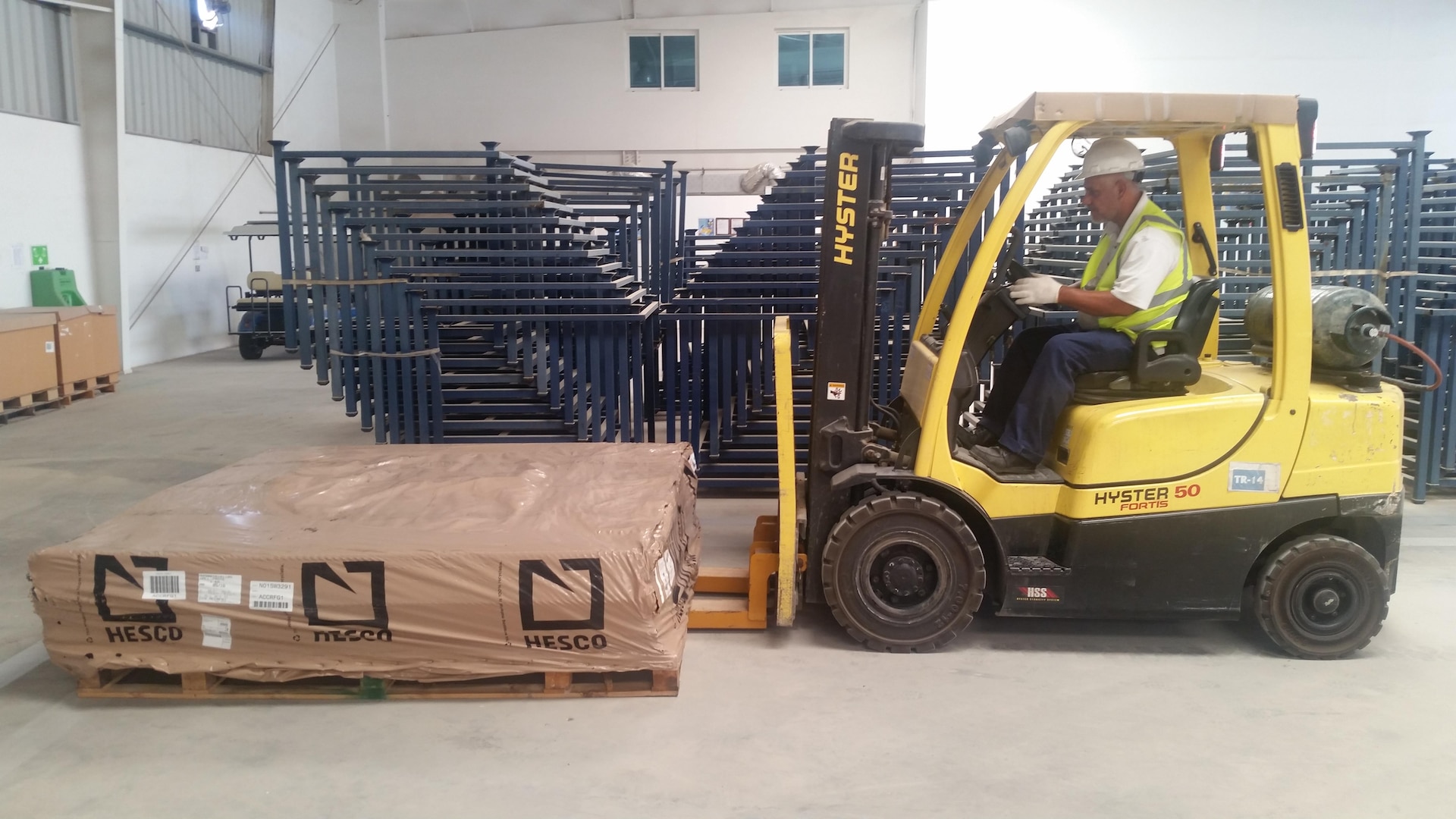 Adel Haider Haji Hasan, a material handling equipment driver at DLA Distribution Bahrain uses a forklift to move the new Class IV materials on July 16.