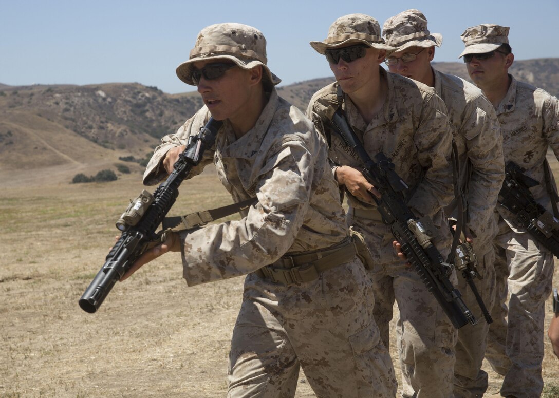 Marines from 1st Battalion, 5th Marine Regiment, 1st Marine Division rush through a door after detonating a breaching charge at Camp Pendleton, Calif., July 26, 2016. The Marines conducted live-fire training allowing them the opportunity to work with breaching charges and familiarizing them with the capabilities of each charge. (U.S. Marine Corps Photo by Lance Cpl. Bradley J. Morrow)