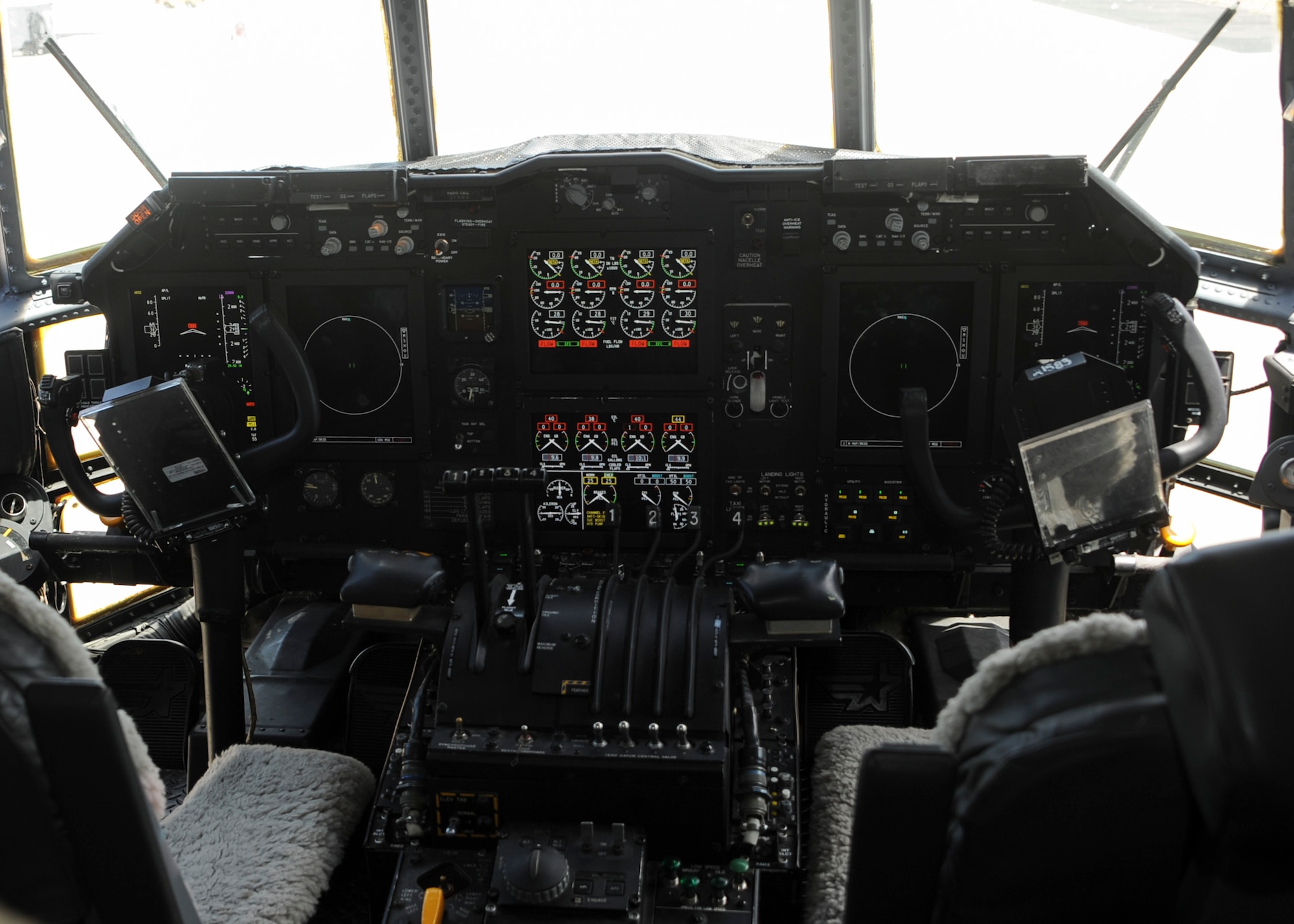 A cockpit upgraded via an avionic viability is powered on for demonstration in an EC-130H Compass Call at Davis-Monthan Air Force Base, Ariz., July 19, 2016. The upgrade revitalizes the cockpit with liquid crystal displays that consolidate vital flight information such as precision ground mapping. (U.S. Air Force photo by Airman Nathan H. Barbour/Released)