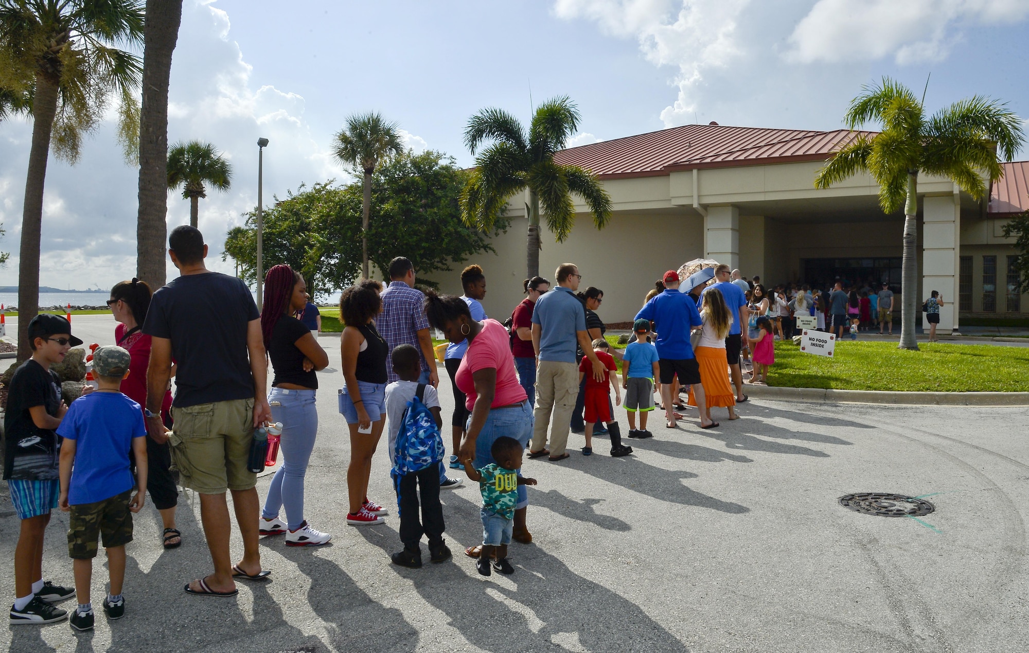 Families line up to receive school supplies and resources during the Back to School Fair at MacDill Air Force Base, Fla., July 30, 2016. The fair is a base-wide, annual event that gathered more than 2,000 military families and children this year. (U.S. Air Force photo by Staff Sgt. Shandresha Mitchell)