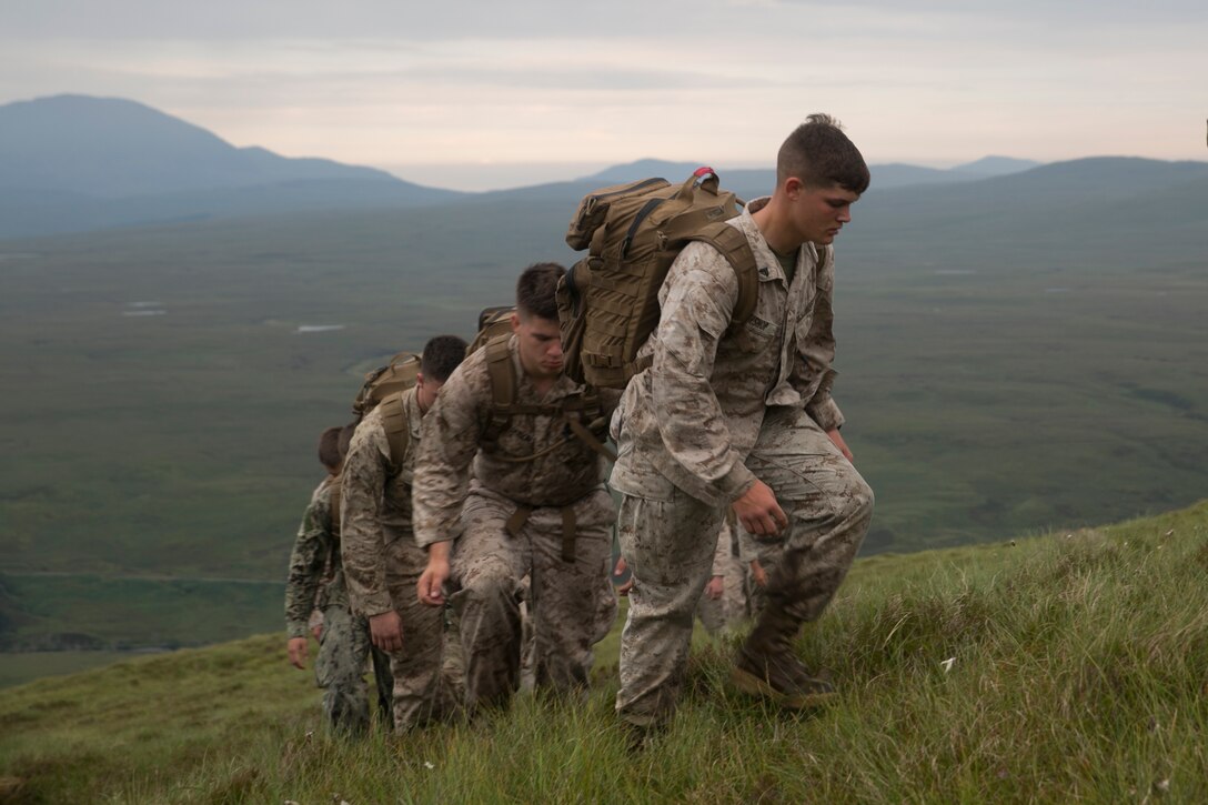 U.S. Marines, sailors and Royal Commandos traverse a mountain in the Scottish Highlands, Inverness, Scotland, July 19, 2016, during the mountain training phase of the Tartan Eagle 16 exercise. This phase consisted of learning mountain survival skills, map reading and how to successfully traverse a mountain. Tartan Eagle is an annual training event that began in 1994. Marines and sailors with Marine Corps Security Force Regiment trained with the 43 Command Fleet Protection Group Royal Commandos to exchange best security and training practices and to foster good relations between the two commands. (Official Marine Corps photo by Sgt. Calvin Shamoon/ Released)