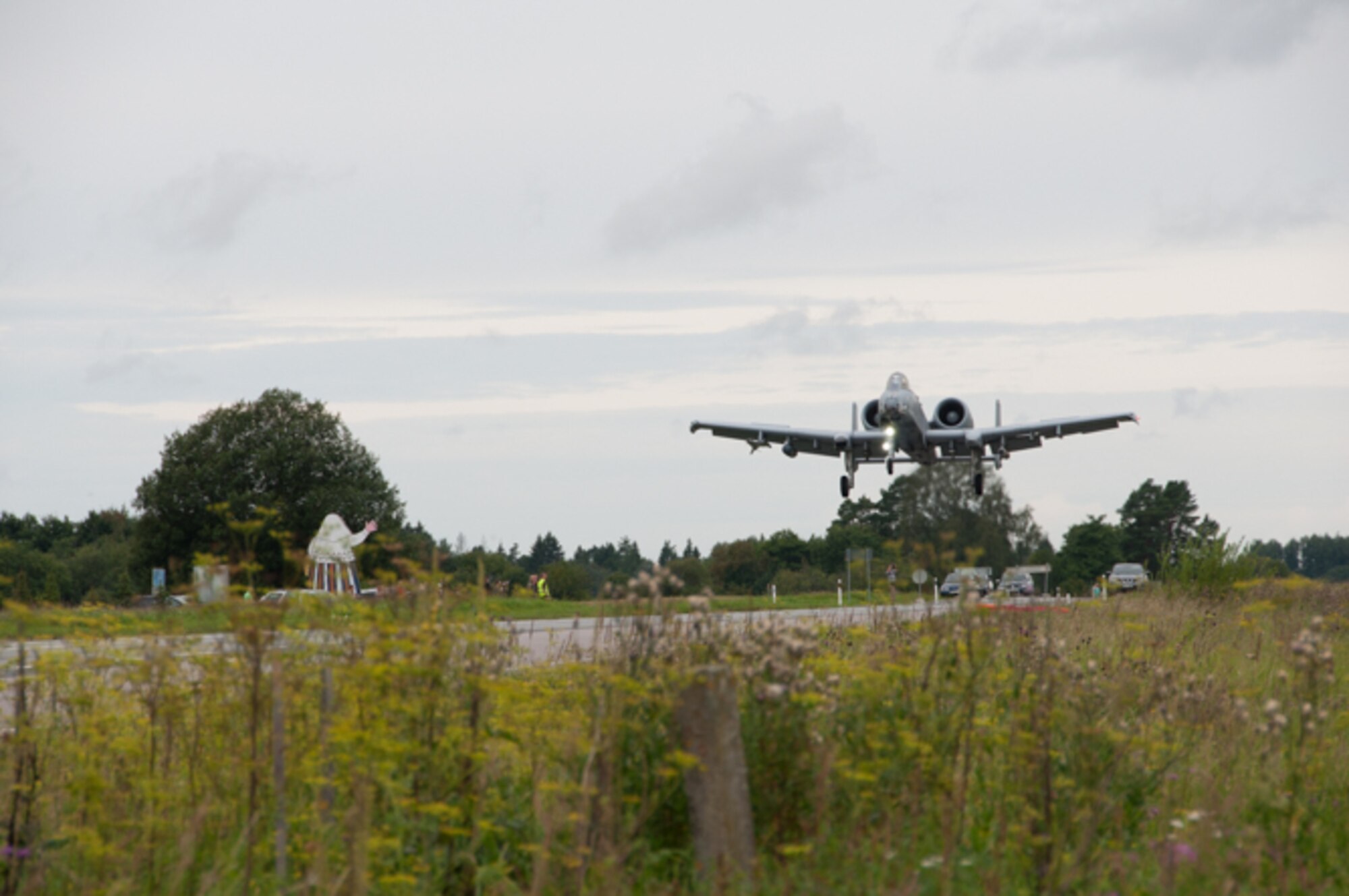 The first of eight A-10s from the 442nd Fighter Wing, Whiteman Air Force Base, Missouri, prepares to land on a highway in Estonia, Aug. 1, 2016. Local authorities removed street signs and provided security by diverting traffic around the strip and containing a crowd of onlookers ranging from local aviation enthusiasts to embassy members. The highway landing highlighted the U.S. Air Force’s tactical capabilities as well as displayed the partnership between the U.S. and Estonia that allowed for the coordination of the event. (U.S. Air Force photo by Senior Airman Missy Sterling/released)