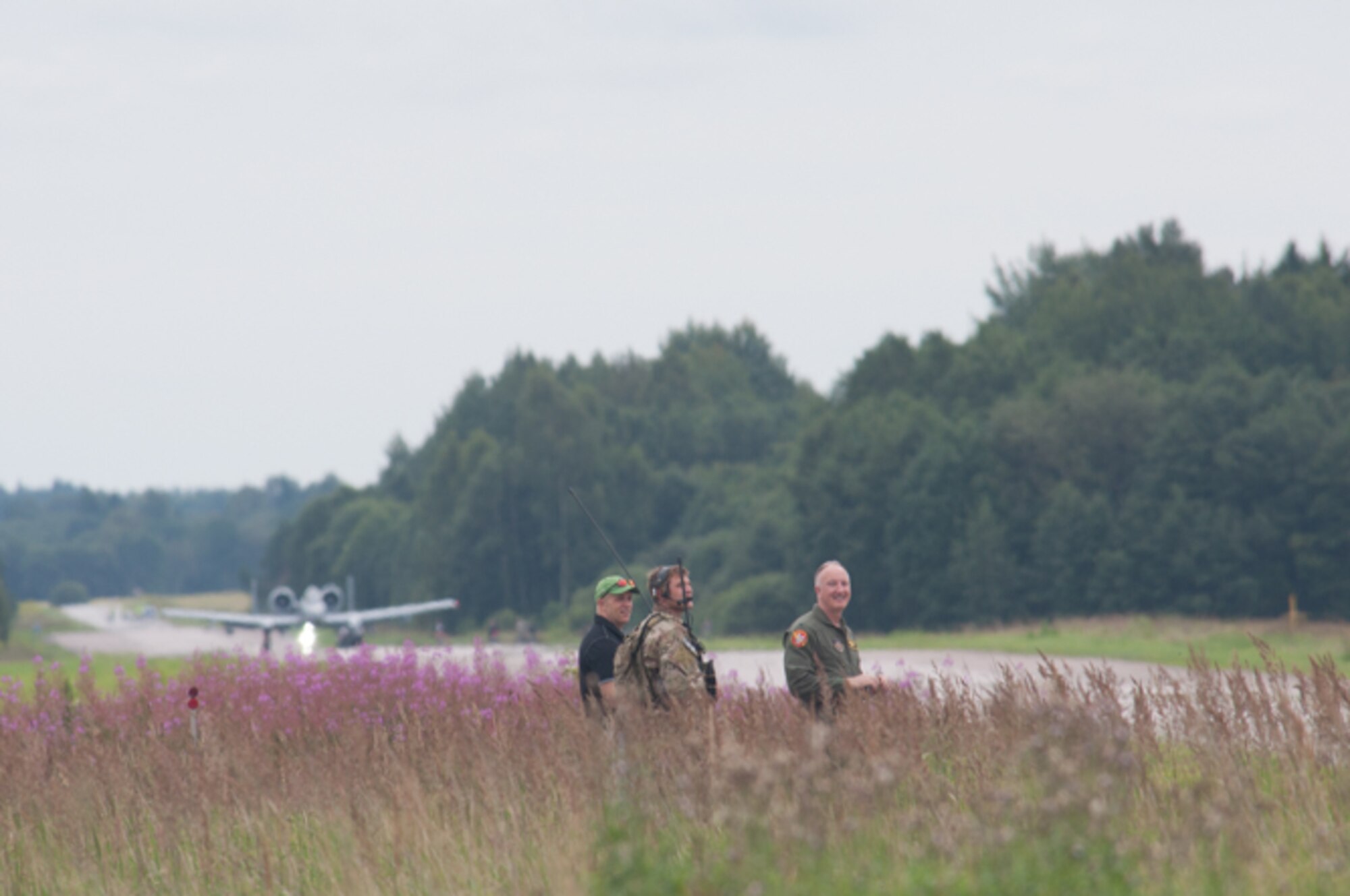Col. Gregory Eckfeld, right, 442nd Fighter Wing vice commander, Whiteman Air Force Base, Missouri, talks with a combat controller acting on behalf of air traffic control, in Estonia, Aug. 1, 2016. The highway was designed during the Cold War era to allow for alternative landing space in case primary landing strips were unavailable during a war. The event highlighted the U.S. Air Force’s tactical capabilities as well as displayed the partnership between the U.S. and Estonia that allowed for the coordination of the event (U.S. Air Force photo by Senior Airman Missy Sterling/released)