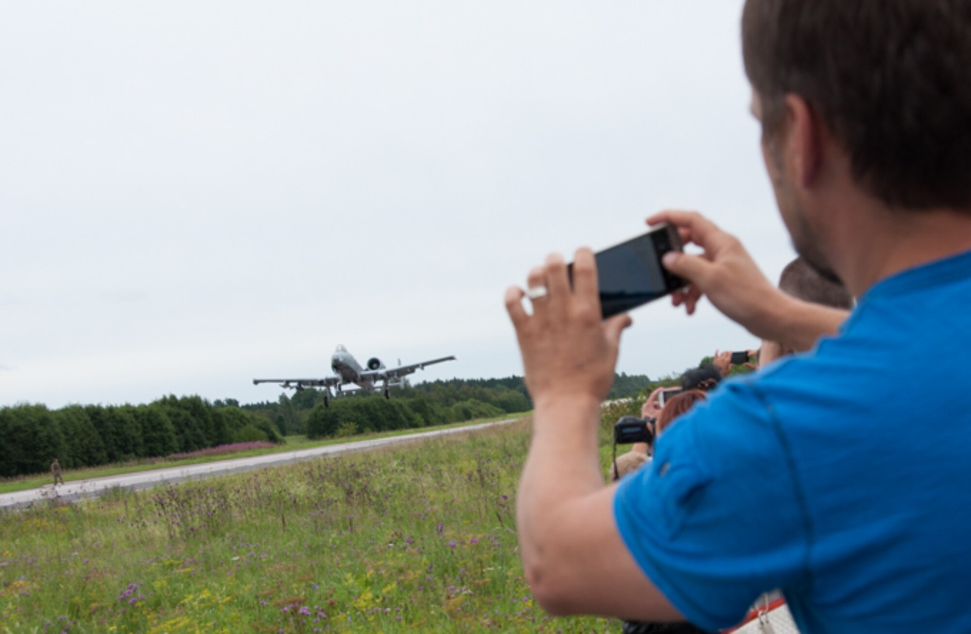 An A-10 from the 442nd Fighter Wing at Whiteman Air Force Base, Missouri, takes-off from a highway in Estonian while members of the crowd take photos, Aug. 1, 2016. Some Estonians traveled more than an hour to see the aircraft complete a rare landing that has only been completed twice in the last 30 years. The highway landing highlighted the U.S. Air Force’s tactical capabilities as well as displayed the partnership between the U.S. and Estonia that allowed for the coordination of the event. (U.S. Air Force photo by Senior Airman Missy Sterling/released)
