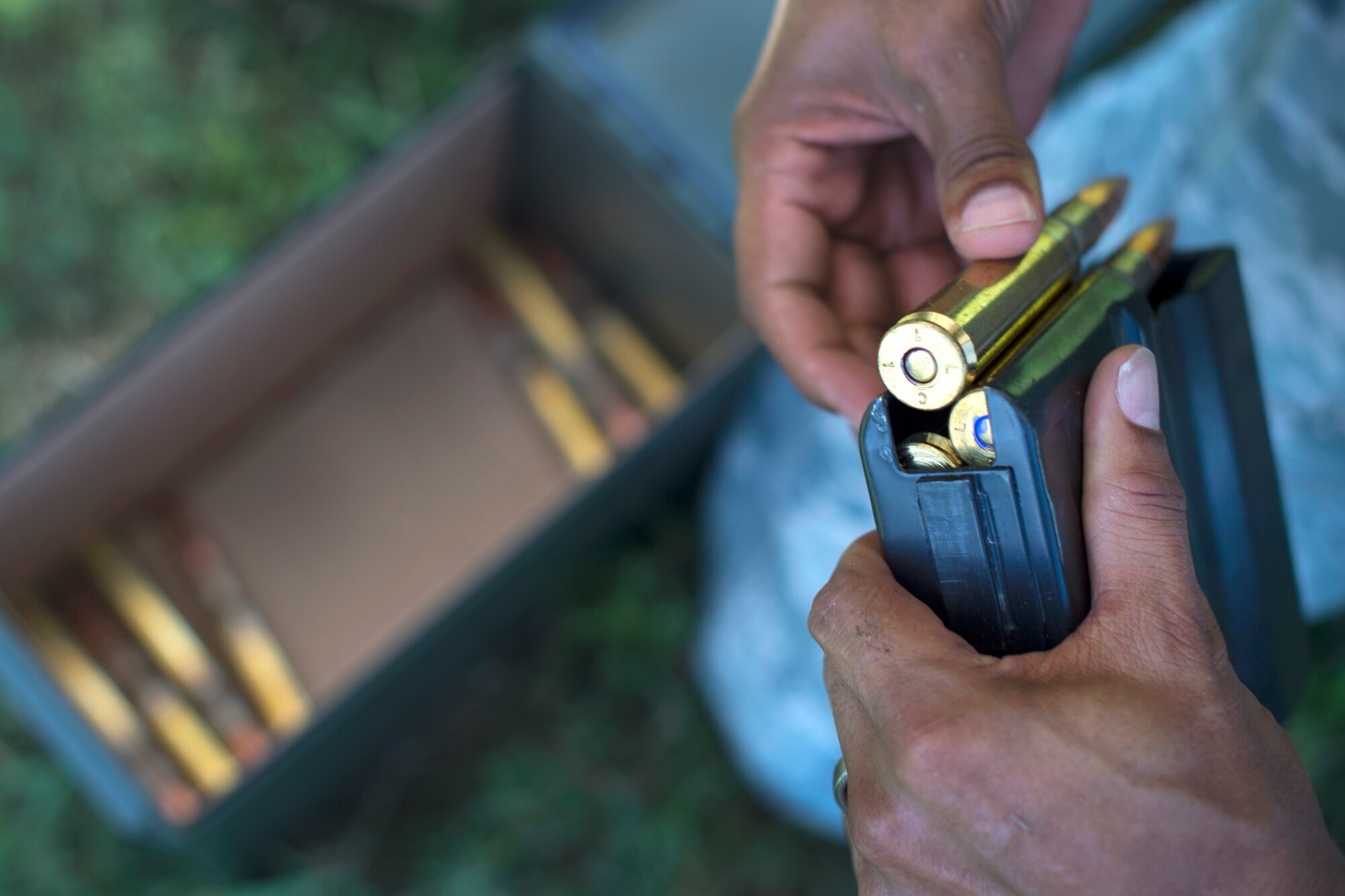 An 11th Security Support Squadron Combat Arms instructor loads a magazine for a Barrett M107 rifle with .50-caliber rounds at Marine Corps Base Quantico, Va., July 15, 2016. Joint Base Andrews combat arms instructors shot two weapon systems to familiarize themselves with the weapons to instruct other service members requiring sniper training. (U.S. Air Force photo by Airman 1st Class Philip Bryant)