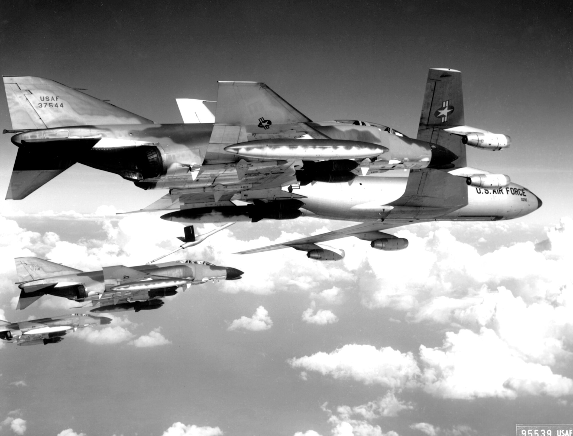 A flight of U.S. Air Force F-4C Phantom fighter bombers refuel from a KC-135 tanker aircraft prior to making a strike against communist targets in North Vietnam.  The Phantoms are fully loaded with 750 pound general purpose bombs and rockets.