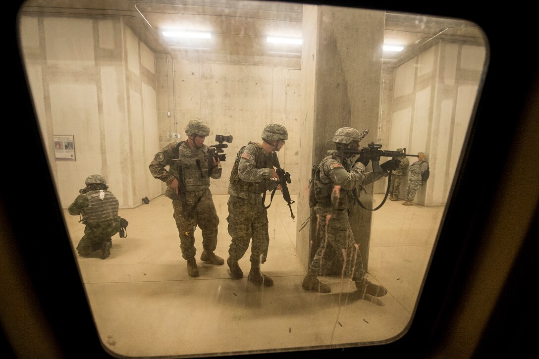 Combat camera photographers move with soldiers through a simulated subway station at Fort A.P. Hill, Va., July 27, 2016, during the North America Information Operations/Combat Camera Exercise. DoD photo by EJ Hersom