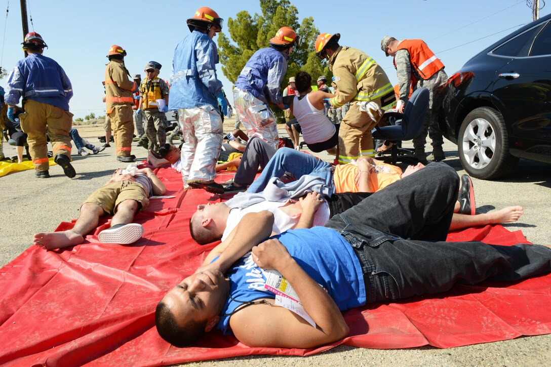 Victims are treated in the parking lot of Bldg. 2850 where a makeshift triage station was set up to treat the wounded. Exercise Desert Wind 16-05 tested Edwards AFB's response to an active shooter scenario. (U.S. Air Force photo by Kenji Thuloweit)