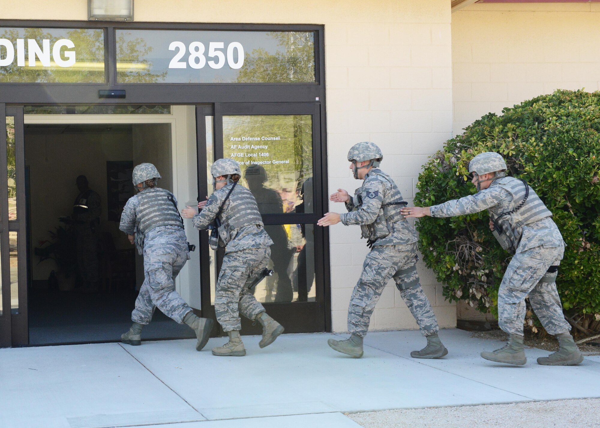 Members of the 412th Security Forces Squadron storm Bldg. 2850 looking for an active shooter during Exercise Desert Wind 16-05 Aug. 1. (U.S. Air Force photo by Kenji Thuloweit