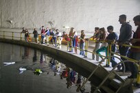 Student interns at Naval Surface Warfare Center, Carderock Division, pilot watertight proof-of-concept vehicles in the David Taylor Model Basin during the inaugural Naval Sea Systems Command Additive Manufacturing (AM) Challenge in West Bethesda, Md., July 28, 2016. The AM Challenge gave interns one month to design and build a proof-of-concept vehicle with a standard kit of parts and the command’s 3-D printers, then maneuver them through an obstacle course. (U.S. Navy photo by Dustin Q. Diaz/Released)