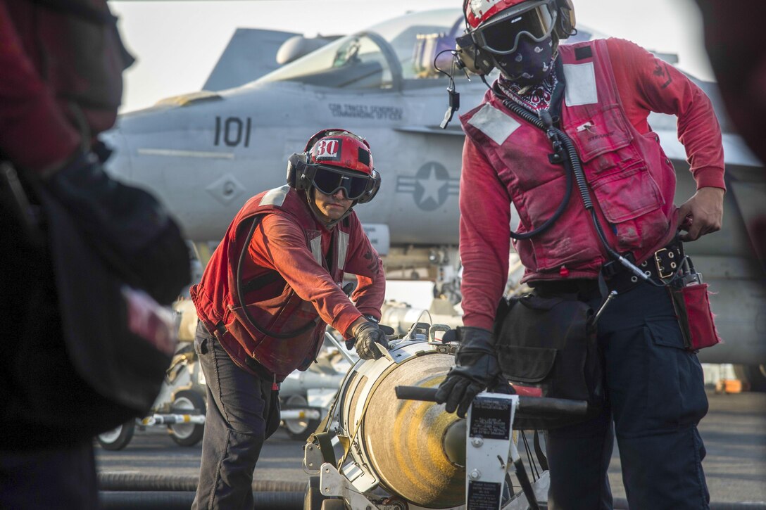 Sailors transport an MK 84/BLU 117 bomb on the flight deck of the USS Eisenhower in the Arabian Sea, July 31, 2016. The Eisenhower is supporting Operation Inherent Resolve, maritime security operations and theater security cooperation efforts in the U.S. 5th Fleet area of operations. Navy photo by Petty Officer 3rd Class Nathan T. Beard