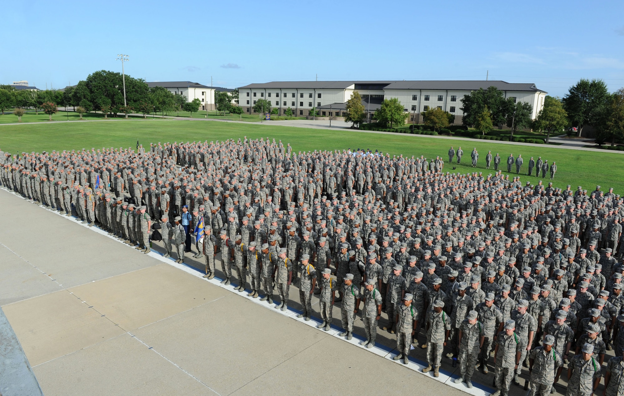 Airmen from the 81st Training Group stand in formation during the 81st TRG Dragon Recognition Ceremony on the drill pad at the Levitow Training Support Facility July 28, 2016, on Keesler Air Force Base, Miss. The monthly event recognized the Airman of the Month for June, the 2016 second quarter Military Training Flight of the Month and Military Training Leader Dragon Award winner as well as Airmen promotees. (U.S. Air Force photo by Kemberly Groue/Released)