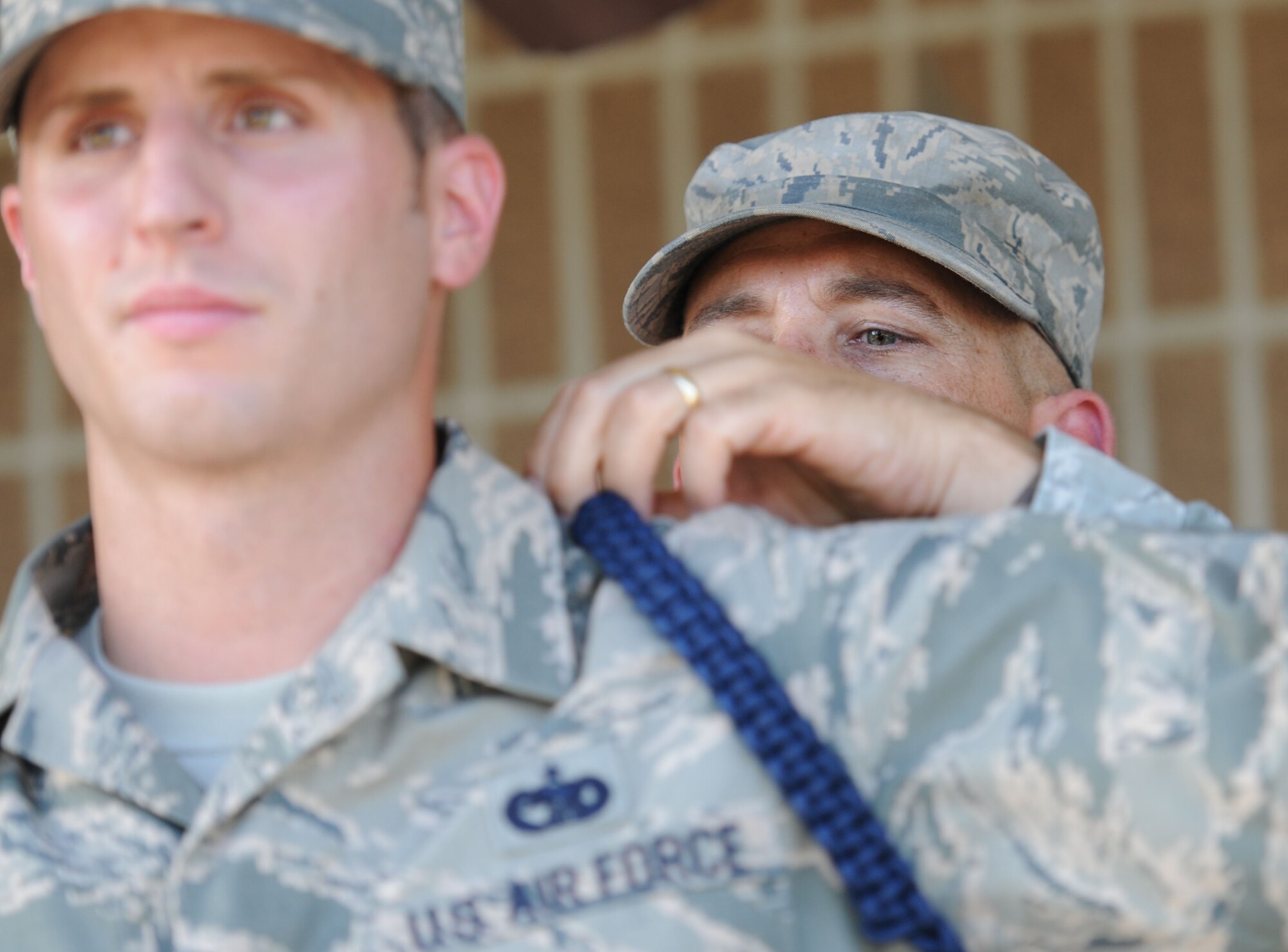 Chief Master Sgt. Robert Winters, 81st Training Group superintendent, presents a blue rope to Staff Sgt. Jeremy Smith, 81st Training Support Squadron military training leader course student, during a graduation ceremony at the Levitow Training Support Facility July 28, 2016, on Keesler Air Force Base, Miss. The program is designed to mentor, train and lead Airmen in technical training as MTLs. The graduation ceremony was held in conjunction with the 81st Training Group Dragon Recognition Ceremony. (U.S. Air Force photo by Kemberly Groue/Released)