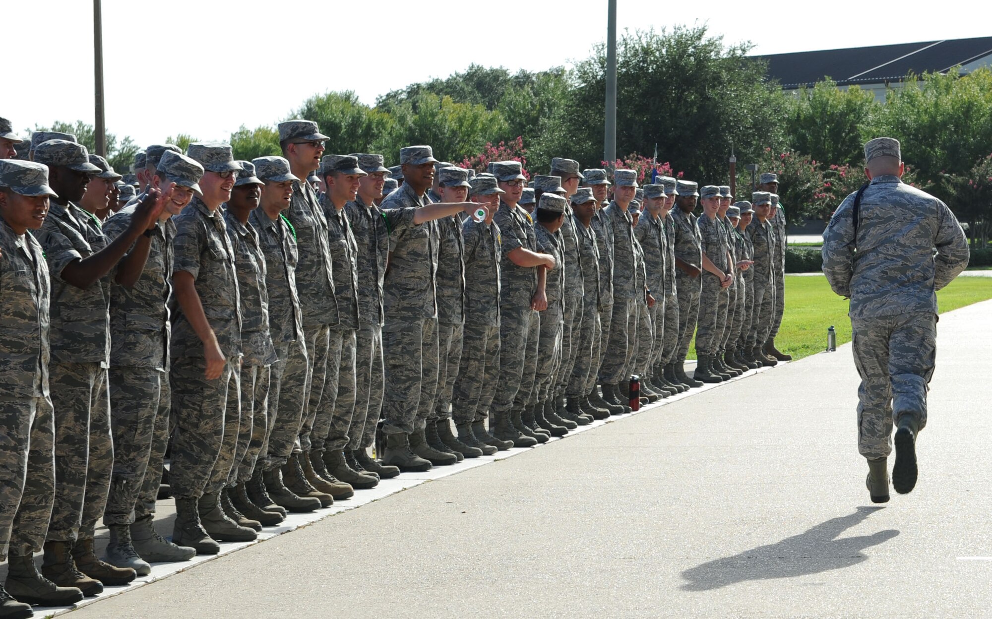 Staff Sgt. David Yawn, 336th Training Squadron military training leader, runs in front of 336th TRS Airmen after being awarded the second quarter Military Training Leader Dragon Award winner during the 81st Training Group Dragon Recognition Ceremony on the drill pad at the Levitow Training Support Facility July 28, 2016, on Keesler Air Force Base, Miss. The monthly event also recognized the Airman of the Month for June, the 2016 second quarter Military Training Flight of the Month and new Airmen promotees. (U.S. Air Force photo by Kemberly Groue/Released)