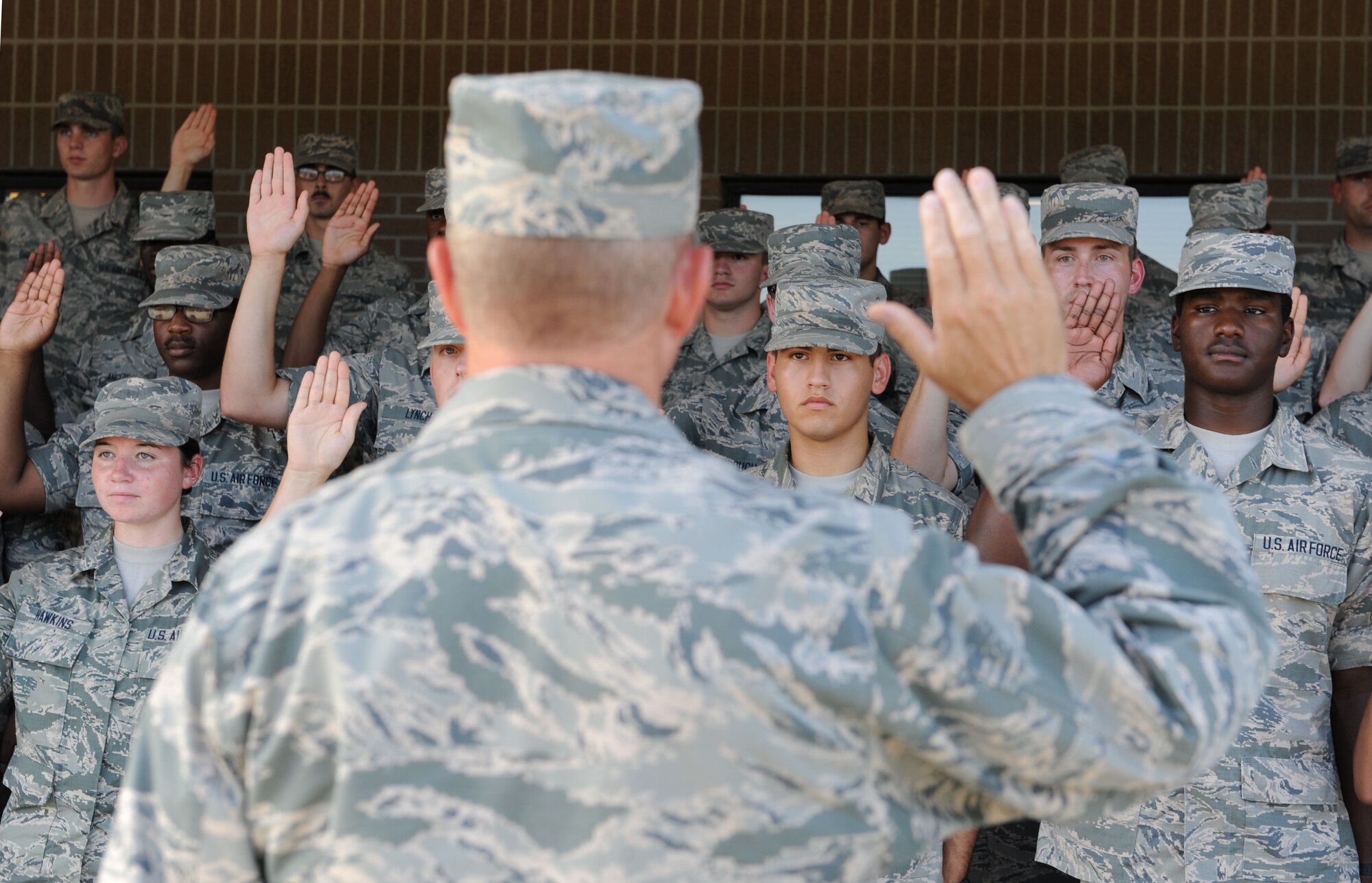 Col. Scott Solomon, 81st Training Group commander, administers the oath of enlistment to the Training Group’s 152 newest Airmen promotees during the 81st Training Group Dragon Recognition Ceremony on the drill pad at the Levitow Training Support Facility July 28, 2016, on Keesler Air Force Base, Miss. The monthly event also recognized the Airman of the Month for June, the 2016 second quarter Military Training Flight of the Month and Military Training Leader Dragon Award winner. (U.S. Air Force photo by Kemberly Groue/Released)