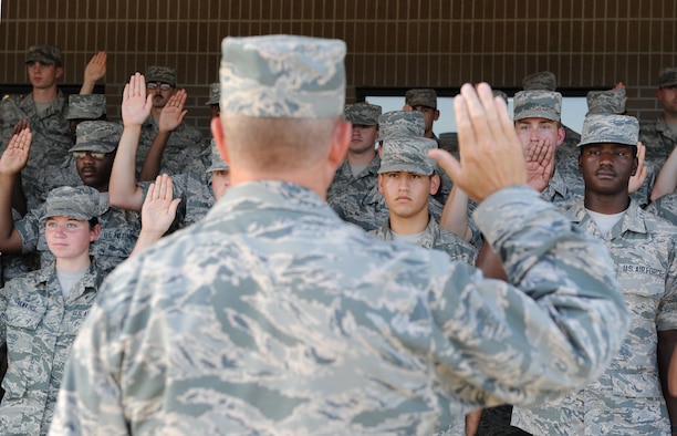 Col. Scott Solomon, 81st Training Group commander, administers the oath of enlistment to the Training Group’s 152 newest Airmen promotees during the 81st Training Group Dragon Recognition Ceremony on the drill pad at the Levitow Training Support Facility July 28, 2016, on Keesler Air Force Base, Miss. The monthly event also recognized the Airman of the Month for June, the 2016 second quarter Military Training Flight of the Month and Military Training Leader Dragon Award winner. (U.S. Air Force photo by Kemberly Groue/Released)