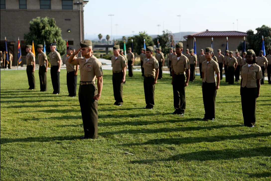 U.S. Marines and Sailors from 1st Marine Logistics Group await the presentation of their awards at a quarterly awards ceremony aboard Camp Pendleton Calif., July 29, 2016. The recipients were recognized at the ceremony for their outstanding achievements in the performance of their duties for the fiscal year 2016 third quarter. (U.S. Marine Corps photo by Sgt. Carson Gramley/released)